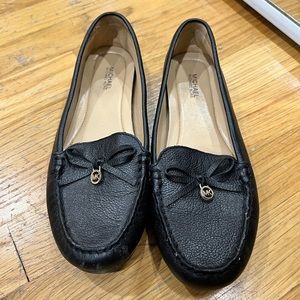 MICHAEL by Michael Kors flat in black with adorable bow and gold charm accent